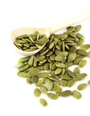 green pumpkin seeds on a white background
