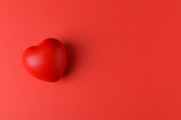 red heart on red background. Selective focus.