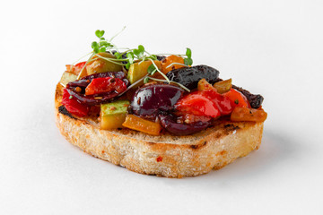 Tasty bruschetta with grilled vegetables. Easy cook, nutritious snack. Beautifully decorated catering banquet menu. Food snacks and appetizers for buffet. Isolated on white background.