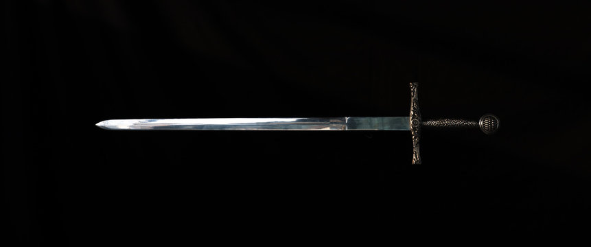 medieval knight's sword on a black background
