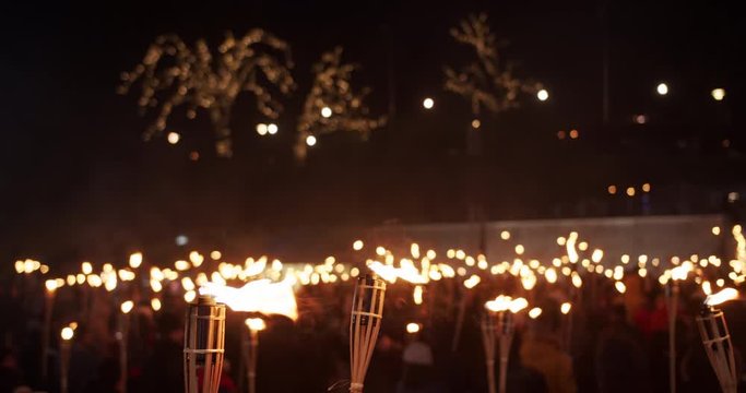 Torchlight procession march at night people with burning torches