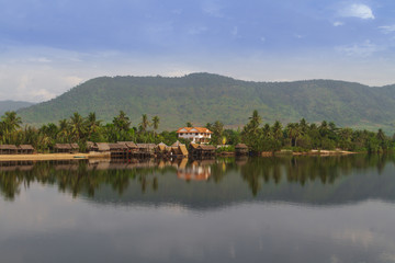 Fototapeta na wymiar Mirror image of jungle house by the Preaek Tuek Chhuk River in Kampot