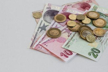 Turkish money twenty,ten and five lira banknotes on the white surface with coins and copy space