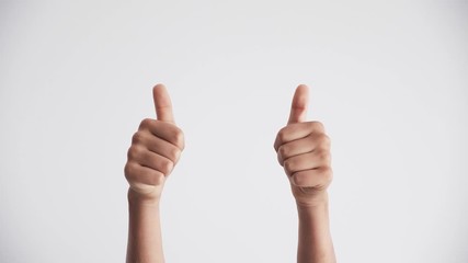 Kid hands clapping applause and showing two thumbs up gesture over white background