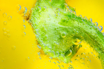 yellow bell pepper close- up macro, selective focus. in the water , under the water.