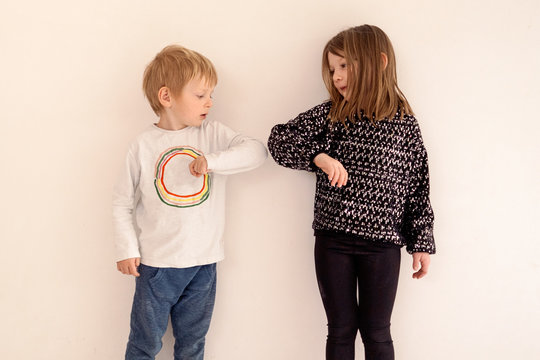 elbow bump is a new way to greetings each other at the time of the coronavirus pandemic outbreak - Powered by Adobe