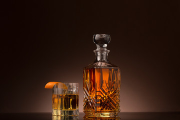 Whiskey old fashioned in crystal glass with decanter