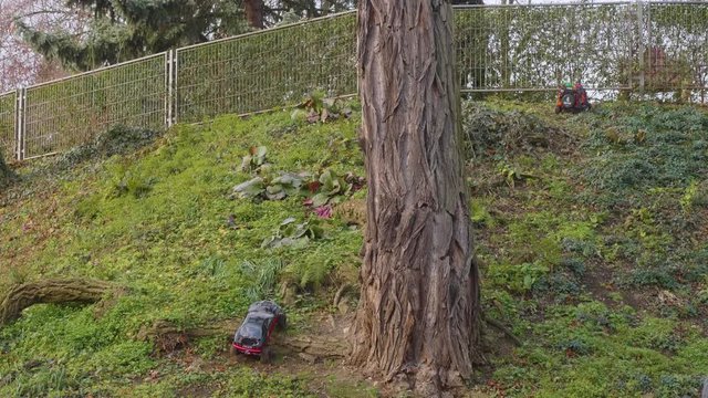 Radio-controlled models of cars ride on paving stones and lawns