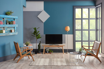 Decorative living room blue grey and white wall concept with black window. Wooden chair and furniture decor. lamp clock and carpet design.