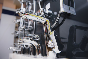 Rows of new faucets in plumbing shop, closeup