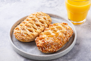 Fresh  pastries on a plate with orange juice. Healthy breakfast concept.