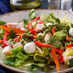 Chicken salad with pesto sauce and mozzarella cheese. Closeup