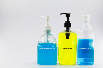 Three bottle of sanitizing set with text on bottle. They are sanitizing hand gel, hand soap and alcohol 70% on white background and space for text.