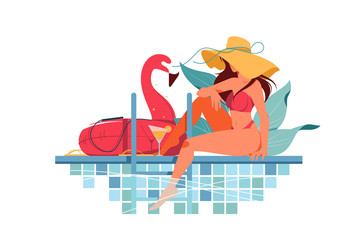 Attractive young woman silhouette with hat near pool drinking fresh.