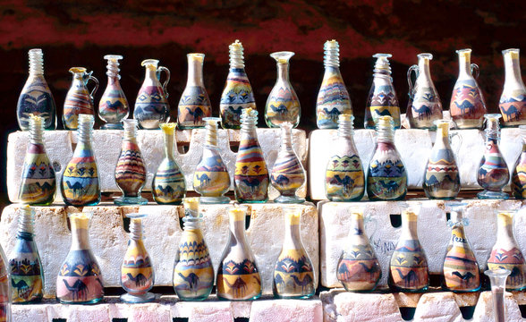 Bottles filled with pictures formed from multicoloured sand, Jordan