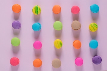 Creative composition with envelope and cake macaron or macaroon on pink pastel background top view. Flat lay.