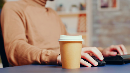 Close up of male engineer picking up his coffee