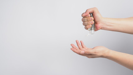Hands is squeezeing alcohol hand gel on white background.