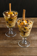 Traditional Dessert Asure,Noah's Pudding designed in stylish glasses on wooden table with Jute...