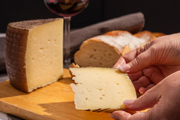 Manchego cheese on wooden table.