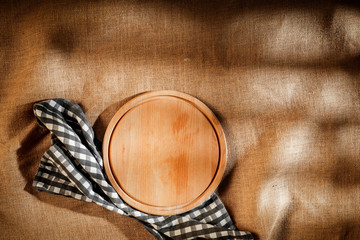 Flat light brown beige linen background seen from above with copy space for advertising products.