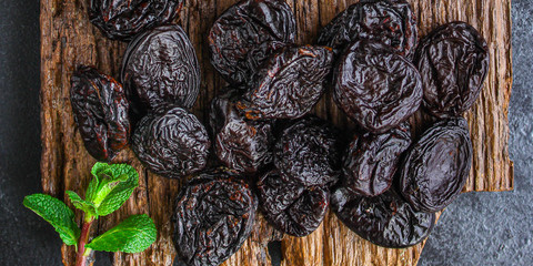 prunes, dried plums (tasty and healthy fruits) desiccated keto or paleo diet menu concept....