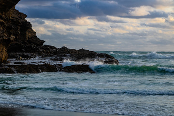 Clouds rolling in and ocena swelling. Bethels Beach, Auckalnd, New Zealand