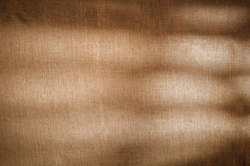 Flat light brown beige linen background seen from above with copy space for advertising products.