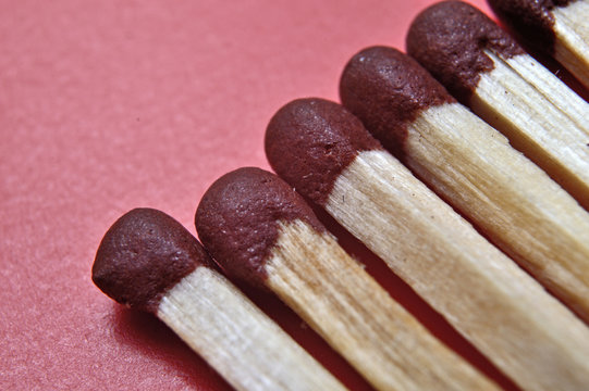 several matches on a red background. macro shot.