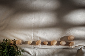Eggs with Flat light brown beige linen background seen from above with copy space for advertising...