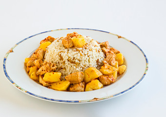 Traditional Turkish Cuisine with rice and chicken cooked with potatoes in plate on white with copy space.