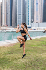 Healthy lifestyle. Fitness woman runner running on the skyscrapers background