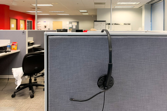 headphone hanging on cubicle wall in a call center 