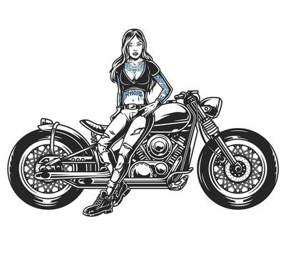 Attractive biker girl standing near motorcycle