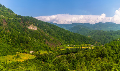Fototapeta na wymiar Mountain landscape with rare rural houses in Montenegro