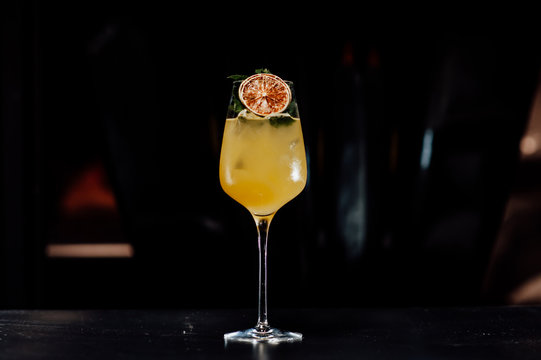 cocktail in a dark key, on a dark background, with different metal details