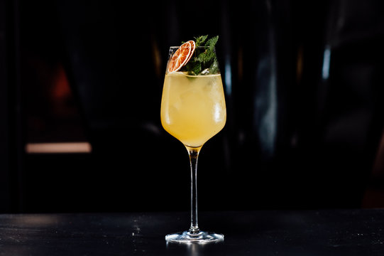 cocktail in a dark key, on a dark background, with different metal details