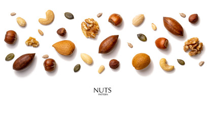 Creative layout made of hazelnut nuts, almonds, walnut, peanut, pecan, sunflower seeds. Flat lay with copy space. Fresh food concept. Nuts isolated on white background.