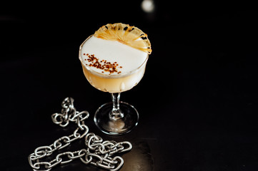 cocktail in a dark key, on a dark background, with different metal details