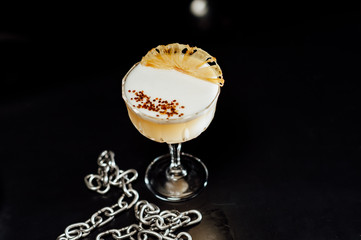 cocktail in a dark key, on a dark background, with different metal details