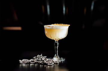 cocktail in a dark key, on a dark background, with different metal details