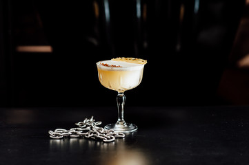 cocktail in a dark key, on a dark background, with different metal details