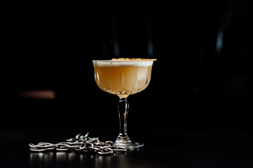 cocktail in a dark key, on a dark background, with different metal details