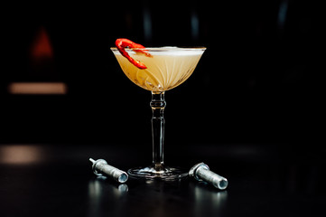 cocktail in a dark key, on a dark background, with different metal details