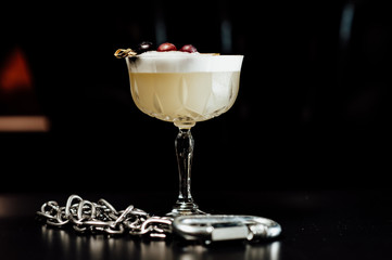 cocktail in a dark key, on a dark background, with different metal details