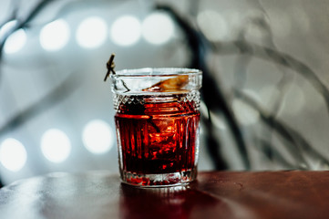 cocktail in a dark key, on a dark background, with different metal details