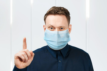 man wearing protective face mask prevent virus infection, pollution with idea pointing finger