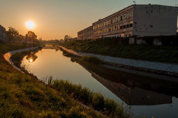 Naklejka premium A view of the Bega river early in the morning. Sunrise in the city. The leather and glove factory.