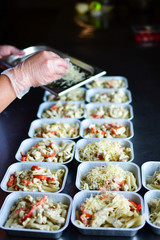 Food delivery. preparing food portions in containers. delivery service during quarantine covid-19. Chicken with vegetables and cheese. airline food. airline meals and snacks. takeaway selective focus