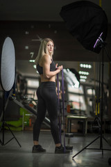 Young girl posing with rubber straps at the gym.